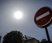 This photograph taken in Paris on 25 May 2026 shows the sun shining above a no-entry road sign during an exceptionally early heatwave, as French weather service Mto-France placed the capital under yellow alert with temperatures forecast to reach 35C across the region. - AFP - STEPHANE DE SAKUTIN