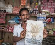 A supporter of Ethiopias ruling Prosperity Party displays a party campaign flyer at his grocery shop in Beshasha, the hometown of Ethiopian Prime Minister Abiy Ahmed, 28 May 2026. - AFP - MARCO SIMONCELLI