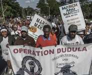 Members of “March and March” and “Operation Dudula” chant anti-migrant slogans during a protest march in Durban, South Africa, in May 2026. - Source: Rajesh Jantilal/AFP via Getty Images.