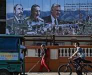 A poster on a street in Havana shows Fidel Castro, his brother Raul Castro, and Cuban President Miguel Daz-Canel on May 20, 2026 -  YAMIL LAGE, AFP