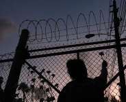 This file photo shows people placing flowers on a fence outside Krome Detention Center in Miami on May 24, 2025, during a vigil to recognise people who died in US Immigration and Customs Enforcement custody as well as those affected by mass deportations. -  Rebecca Blackwell, AP