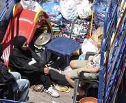 Residents of southern Lebanon fleeing Israeli airstrikes at the entrance to Saida with their belongings on June 19, 2026 -  Mahmoud Zayyat, AFP