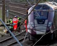Emergency personnel work on a train on the tracks outside Bedford, England, after a train from Corby to London St. Pancras and another from Nottingham to London St. Pancras, collided on Friday June 19, 2026. -  Jamie Lashmar/PA via AP