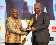 Hon. Joseph Cudjoe receiving award from H.E. John Mahama