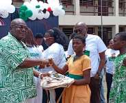 Hon. Mawutor Agbavitor handing over some donated items to a student of Philip Akpo JHS, Bankoe.