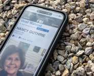 A photo of Nancy Guthrie, mother of the American journalist Savannah Guthrie, on a smartphone, taken February 10, 2026. -  Brandon Bell, AFP