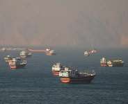 Vessels transit the Strait of Hormuz, seen from Musandam, Oman, on 15 June, as maritime authorities warn of suspected mines in the area. - REUTERS - Stringer
