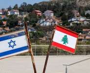 Representations of the Israeli and Lebanese flags at a memorial near the Israel-Lebanon border, after Israel and Lebanon signed a framework agreement following U.S.-mediated talks, as the town of Metula, Israel, appears in the distance, June 27, 2026. -  Amir Cohen, Reuters