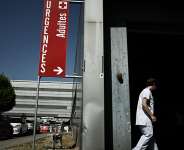 A healthcare worker enters the adult emergency department at the Pellegrin University Hospital during a heatwave in Bordeaux, south-western France on 23 June 2026. - AFP - PHILIPPE LOPEZ