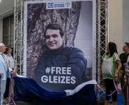 The President of the Bouches-du-Rhone Departmental Council Martine Vassal unveils a banner bearing French sports journalist Christophe Gleizes, detained in Algeria, in the main hall of the Departmental Archives and Library Gaston Deferre in Marseille on 2 June 2026. - AFP - MIGUEL MEDINA