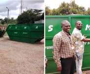 MCE Hon. Emmanuel Kwame Frimpong handing over skip containers to assembly member