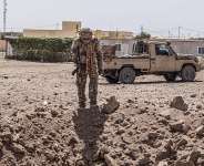 A soldier from the National Front for the Liberation of Azawad (FLA) inspects a crater in Kidal on May 14, 2026 caused by aerial bombardment from Malian Armed Forces (FAMA). - AFP