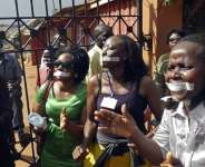 Employees of the Daily Monitor newspaper with their mouths taped shut, during a protest against the closure of their premises by the Uganda government, in the capital Kampala, on 20 May, 2013. - Reuters/James Akena