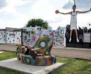 A woman poses for a picture next to a structure depicting French star Victor Wembanyama in San Antonio ahead of the San Antonio Spurs NBA Finals showdown with the New York Knicks. - Ronaldo Schemidt, AFP