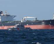 A French Navy vessel sails by the Russian oil tanker Tagor, suspected of flying a false Cameroonian flag and boarded by the French Navy on May 31, 2026. - Fred Tanneau, AFP