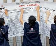 Peruvian electoral workers place a polling station list in Lima, Peru on June 6, 2026. -  Stifs Paucca, Reuters