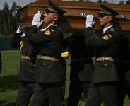 Ukraines President Volodymyr Zelensky (L) attends the reburial ceremony of Andriy Melnyk, who died in 1964 and was the leader of a branch of the Organisation of Ukrainian Nationalists (OUN), along with his wife Sofia, at the National Military Memorial Cemetery near Kyiv on May 25, 2026. -  Genya Savilov, AFP