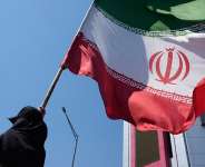 A woman holds an Iranian flag during a pro-government campaign in downtown Tehran on June 8, 2026. -  Vahid Salemi, AP