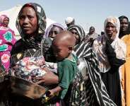 Women displaced from El Fasher queue for food aid at Al-Afadh camp in Al Dabbah, northern Sudan, in November 2025, after fleeing fighting in North Darfur. - AP - Marwan Ali