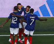 Frances Kylian Mbappe celebrates scoring their third goal with teammates. - Jeenah Moon, Reuters