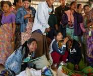 Mourners grieve as bodies are laid out at a cemetery after a Myanmar military strike at a hospital killed more than 30 people in western Rakhine state on December 11, 2025. -  AFP file photo