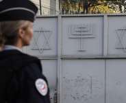 A French police officer stands guard in front of the Synagogue of Sarcelles, Pariss suburb, on October 11, 2023. -  Geoffroy Van Der Hasselt, AFP