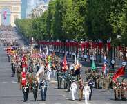 Coalition of volunteers of invited foreign nations march down the Champs-Elyses during the annual Bastille Day military parade, 14 July 2026. - AFP - LUDOVIC MARIN