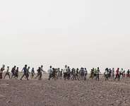 In this July 14, 2019 photo, smugglers lead Ethiopian migrants in Obock, Djibouti to embark on a route via Yemen to reach oil-rich Saudi Arabia to earn enough to escape poverty. - AP - Nariman El-Mofty