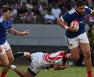 Frances Emmanuel Meafou runs with the ball against Japan. -  Andrew Caballero-Reynolds, AFP