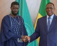 Outgoing Senegalese President Macky Sall shaking hands with with Senegals president-elect Bassirou Diomaye Faye at the Presidential palace in Dakar, on 28 March, 2024. - AFP - -