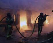 Firefighters put out a blaze at a market during the Russian missile strike on the Ukrainian capital of Kyiv -  Serhii Okunev, AFP
