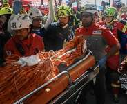 Rescue workers load Hernan Gil, a survivor of Venezuelas twin earthquakes, into an ambulance in Catia La Mar, La Guaira State, Venezuela on July 2, 2026. -  Federico Parra, AFP