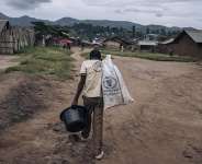 A man carries supplies through Kishishe, eastern Democratic Republic of Congo. Fighting in eastern DRC has displaced millions of people as Rwanda and the DRC seek to implement a US-brokered peace agreement. - Alexis Huguet / AFP