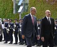 German Chancellor Friedrich Merz (L) and Azerbaijans President Ilham Aliev (R) react after inspecting the honor guard during a welcoming ceremony at the Chancellery in Berlin on July 21, 2026. - AFP - TOBIAS SCHWARZ