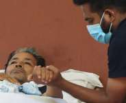 Abhijeet Dipke, head of the Cockroach Janta Party (CJP), holds the hand of Sonam Wangchuk, an Indian education reformer, who has been on hunger strike at Jantar Mantar in New Delhi, India, on July 18, 2026. -  Bhawika Chhabra, Reuters