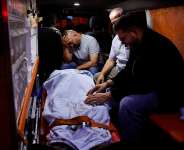Palestinians sit next to the body of a Palestinian aboard an ambulance before their funeral, who was killed in a deadly shooting incident, according to Israeli and Palestinian health officials, near the village of Tal, in Nablus, in the Israeli-occupied West Bank, July 25, 2026. -  Mohammed Torokman, Reuters