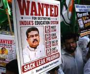 Indian Youth Congress party workers hold placards of Indias Education Minister Dharmendra Pradhan during a protest  over the alleged NEET exam irregularities in Mumbai on June 2, 2026. -  Indranil Mukherjee, AFP