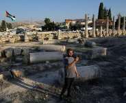 A Palestinian visitor takes a photo at the Roman historical site in the West Bank town of Sebastia on November 20, 2025. -  Nasser Nasser, AP