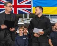 Britains Prime Minister Andy Burnham and Ukraines President Volodymyr Zelensky speak to troops on board the Royal Navy aircraft carrier HMS Queen Elizabeth during their visit to HM Naval Base in Portsmouth on the south coast of England on 27 July 2026. - AFP - SIMON JONES