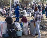 Hundreds of Zimbabwean citizens waiting to be transported home after fleeing South Africa at a repatriation reception camp in Beitbridge, Zimbabwe, 9 July 2026. - AFP - ZINYANGE AUNTONY