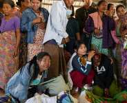 Mourners grieve as bodies are laid out at a cemetery before their burial following a Myanmar military air strike on a hospital that killed more than 30 people, in Mrauk U in northern Rakhine state, on December 11, 2025 AFP