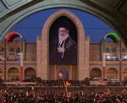 Mourners gather beneath a portrait of the late Iranian supreme leader Ayatollah Ali Khamenei during the funeral ceremonies for Khamenei and members of his family at the Imam Khomeini Mosalla Grand Mosque in Tehran, Iran, Saturday, July 4, 2026. -  Altaf Qadri, AP