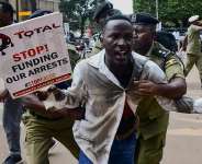 Police apprehend a Ugandan activist during a protest against the East African Crude Oil Pipeline (EACOP) plans in Kampala, Uganda, on 15 September, 2023. -  Reuters