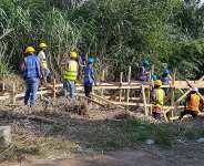 Workers putting up wooden support structures at the site