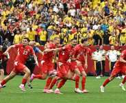 Switzerlands players race to celebrate after Ruben Vargas slots in the winning penalty against Colombia. -  Simon Fearn, Reuters