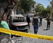 Syrian security personnel inspect a burned vehicle near the Four Seasons Hotel in Damascus, July 7, 2026. -  Omar Albam, AFP