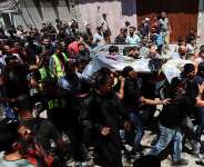 Mourners carry the body of Palestinian man Mohammad al-Waheidi, who worked for the Egyptian Relief Committee and was killed in an Israeli strike on Tuesday, during his funeral, in Gaza City, July 8, 2026. -  Dawoud Abu Alkas, Reuters