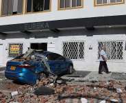 Debris covers a car after an earthquake struck Cali, Colombia, Monday, Aug. 10, 2026. - Santiago Saldarriaga, AP