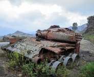 The remains of a tank from clashes between the Ethiopian National Defense Force and the Tigray Peoples Liberation Front on a road near Gereb Agew, Southern Tigray, Ethiopia, 3 March. - AFP - ABEL GEREZGIHER