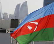 The Azerbaijan flag seen against the skyline of the capital Baku. - AP - Luca Bruno